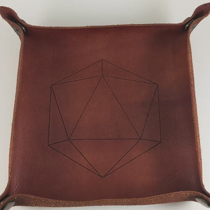 The video starts with a brown leather dice tray in view that has a d20 shape lasered into it. A hand appears from the bottom right corner holding a complete set of dagger dice that are bright orange tempered with deep red like cooling lava with obsidian black numbers. The hand rolls all of the dice into the tray from the right.